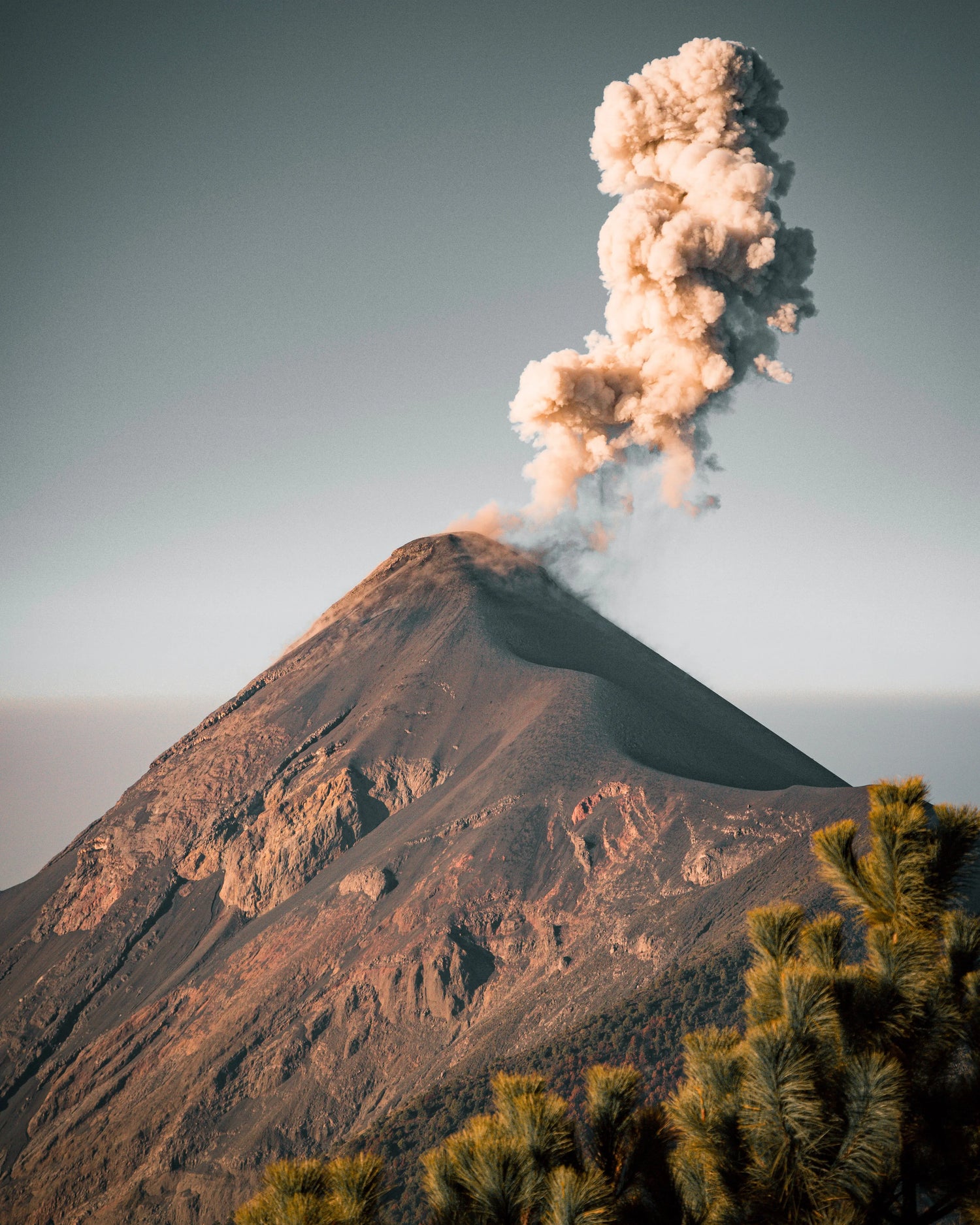 Image of the El Fuego volcano in Guatemala. The volcano is in eruption. 